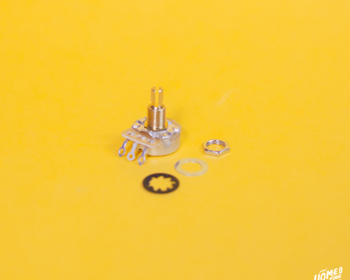 CTS 450G series split standard short shaft pot with it's mounting nut, flat and star washer placed to it's side, on a yellow background with the Home of Tone logo in the corner.