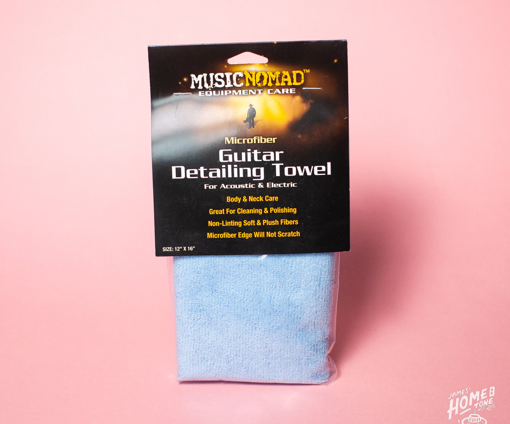 A MusicNomad guitar detailing towel made of microfiber, packaged in a sleeve with branding and product information card on top.