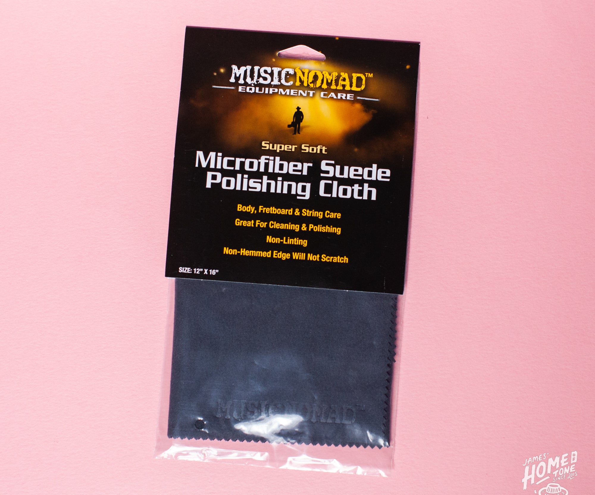 Packaged Microfiber Suede Polishing Cloth by MusicNomad on a pink background.