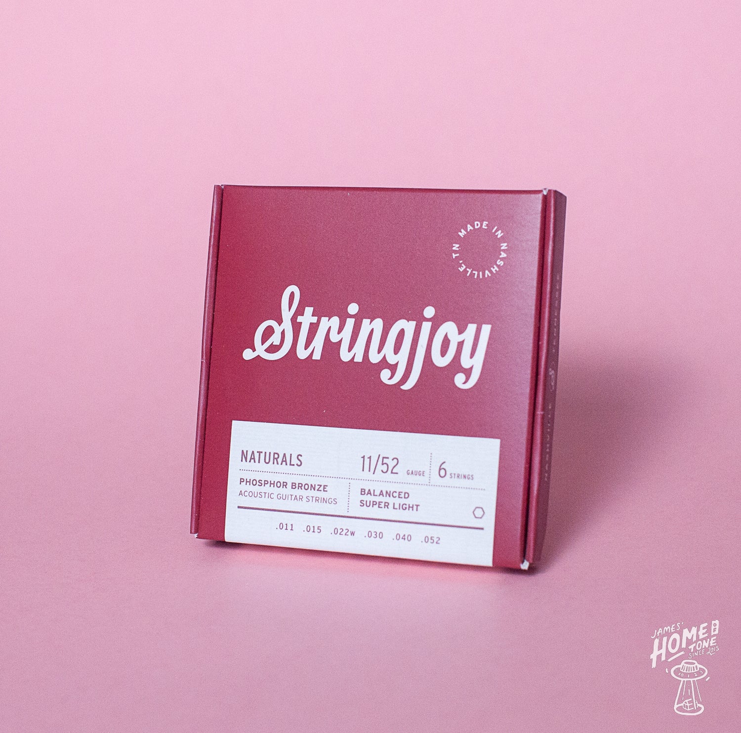 Stringjoy guitar string box on a pink background
