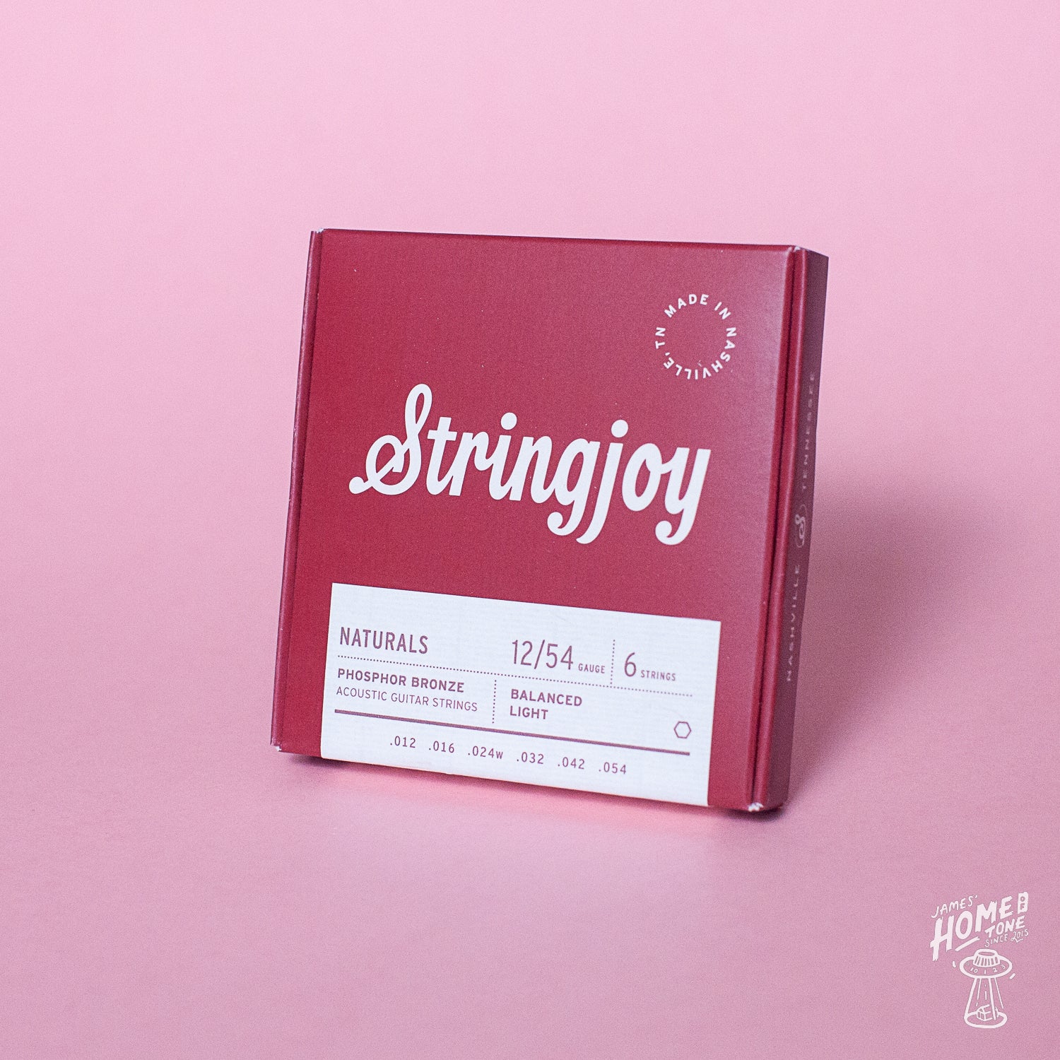 Stringjoy guitar string box on a pink background