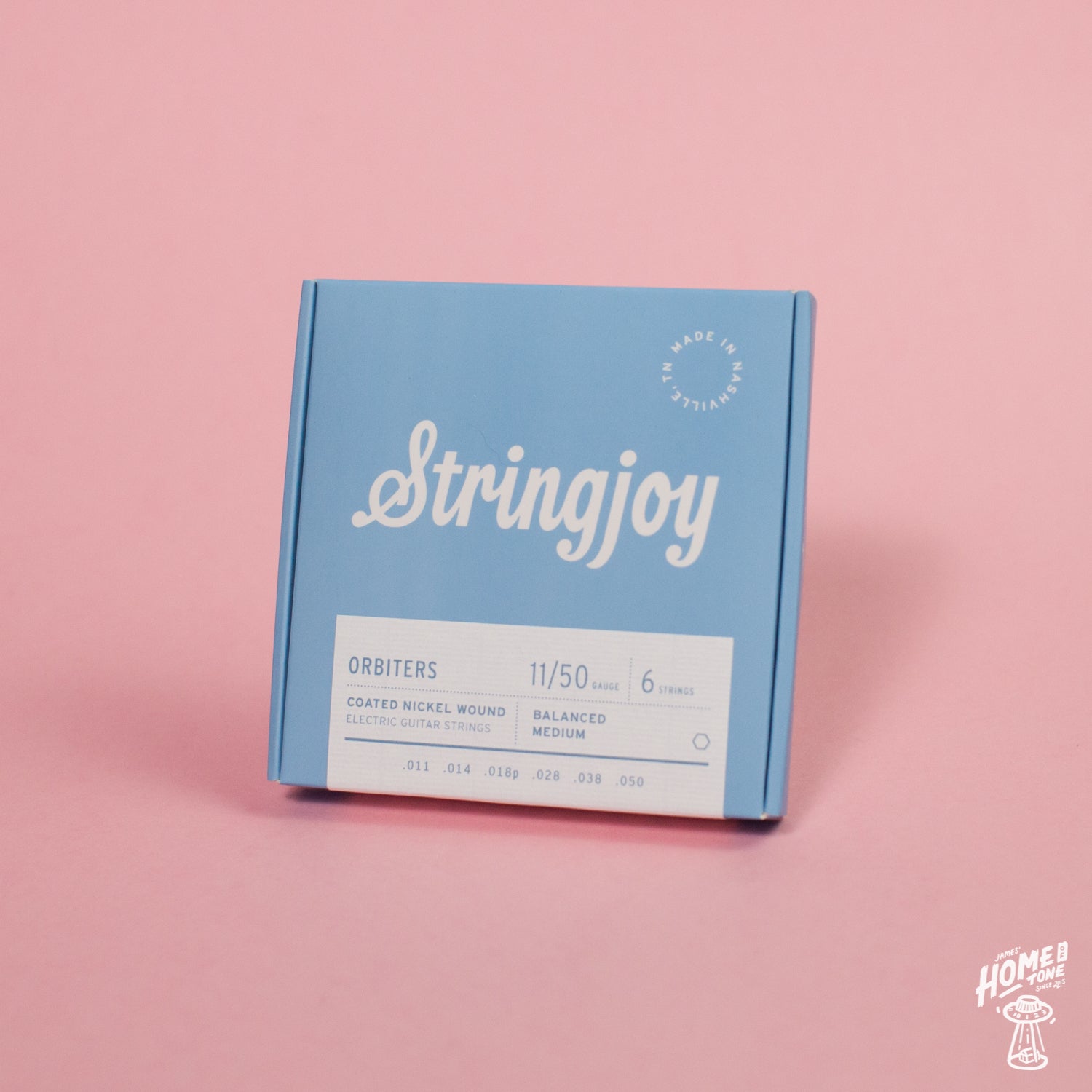 A blue box of Stringjoy Orbiters coated nickel wound electric guitar strings with balanced medium gauge indicated on the packaging.