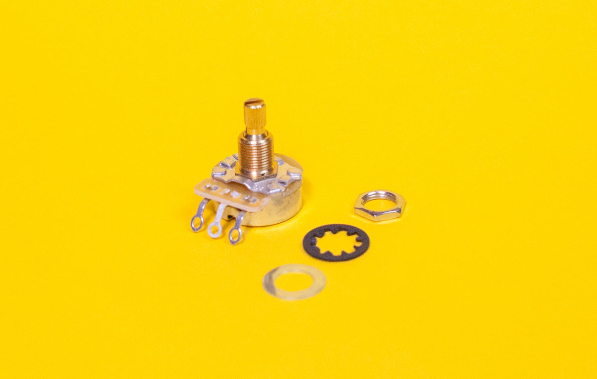 A CTS audio taper potentiometer with a split short shaft, displayed on a yellow background. It includes a yellow cap, a silver-colored shaft, a brass bushing, and a graphite wiper.