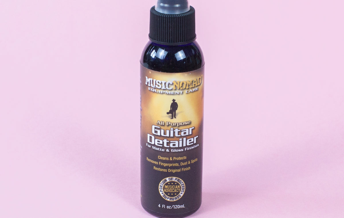 A spray bottle of MusicNomad Guitar Detailer for cleaning and maintaining matte and gloss finished guitars.