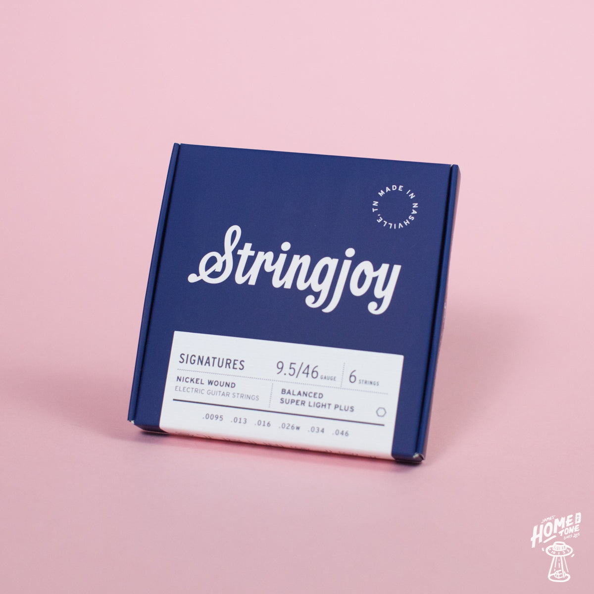 A box of Stringjoy Signature nickel wound electric guitar strings in Balanced Super Light Plus gauge, displayed against a pink background.