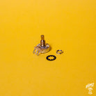 A CTS 450 linear taper series 250k potentiometer with a split short shaft, displayed on a yellow background, accompanied by a nut and star tooth washer.