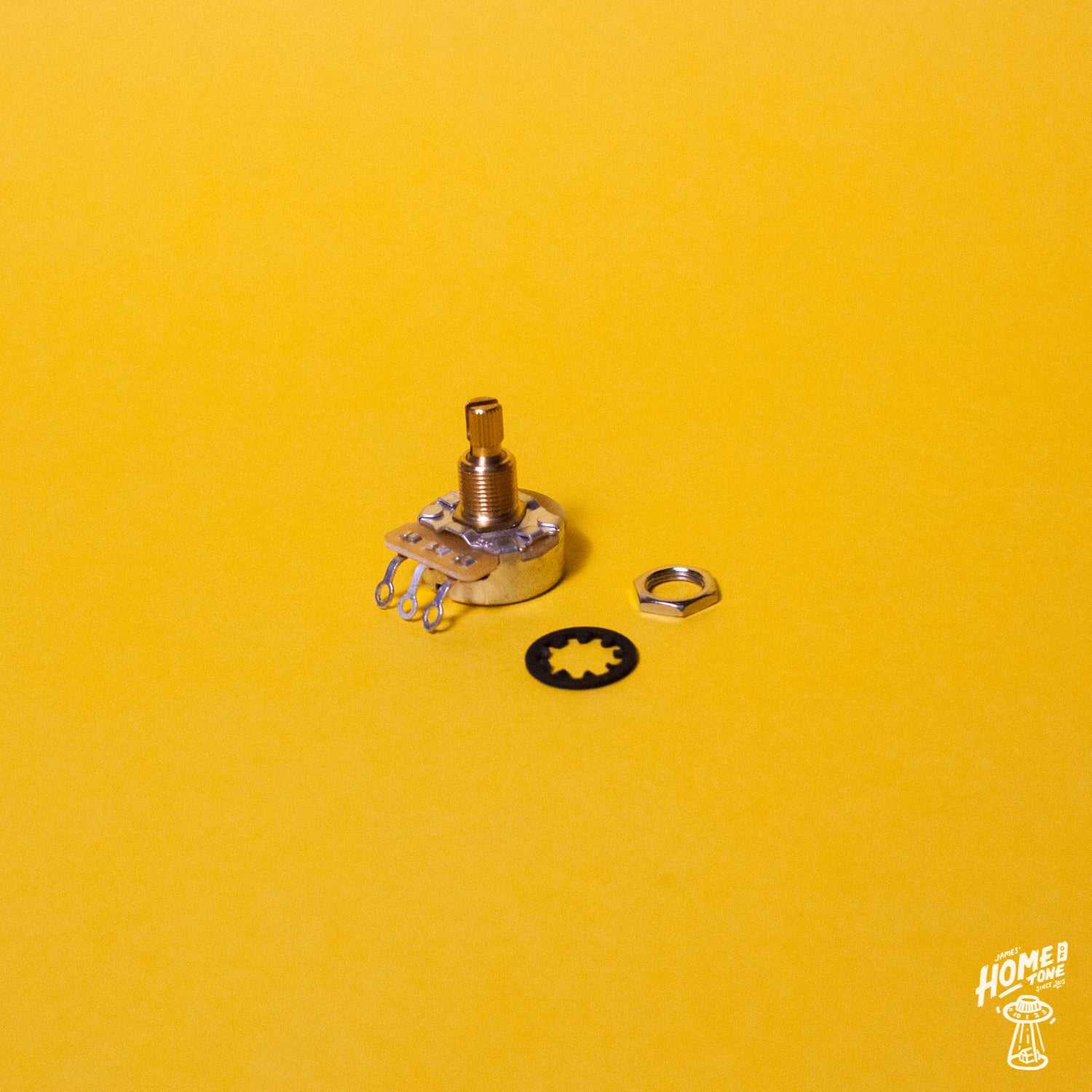 A CTS 450 linear taper series 250k potentiometer with a split short shaft, displayed on a yellow background, accompanied by a nut and star tooth washer.