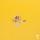 Mechanical potentiometer with washers on a yellow background