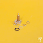 A CTS 450G series long shaft potentiometer placed on a yellow background with the mounting nuts and washers displayed to the side with the Home of Tone logo in the corner of the image.