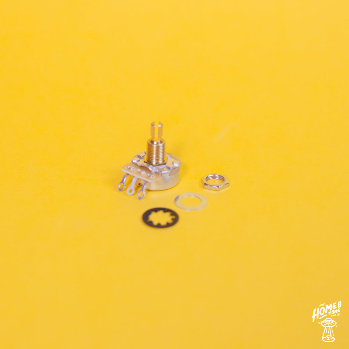 CTS 450G series split standard short shaft pot with it's mounting nut, flat and star washer placed to it's side, on a yellow background with the Home of Tone logo in the corner.