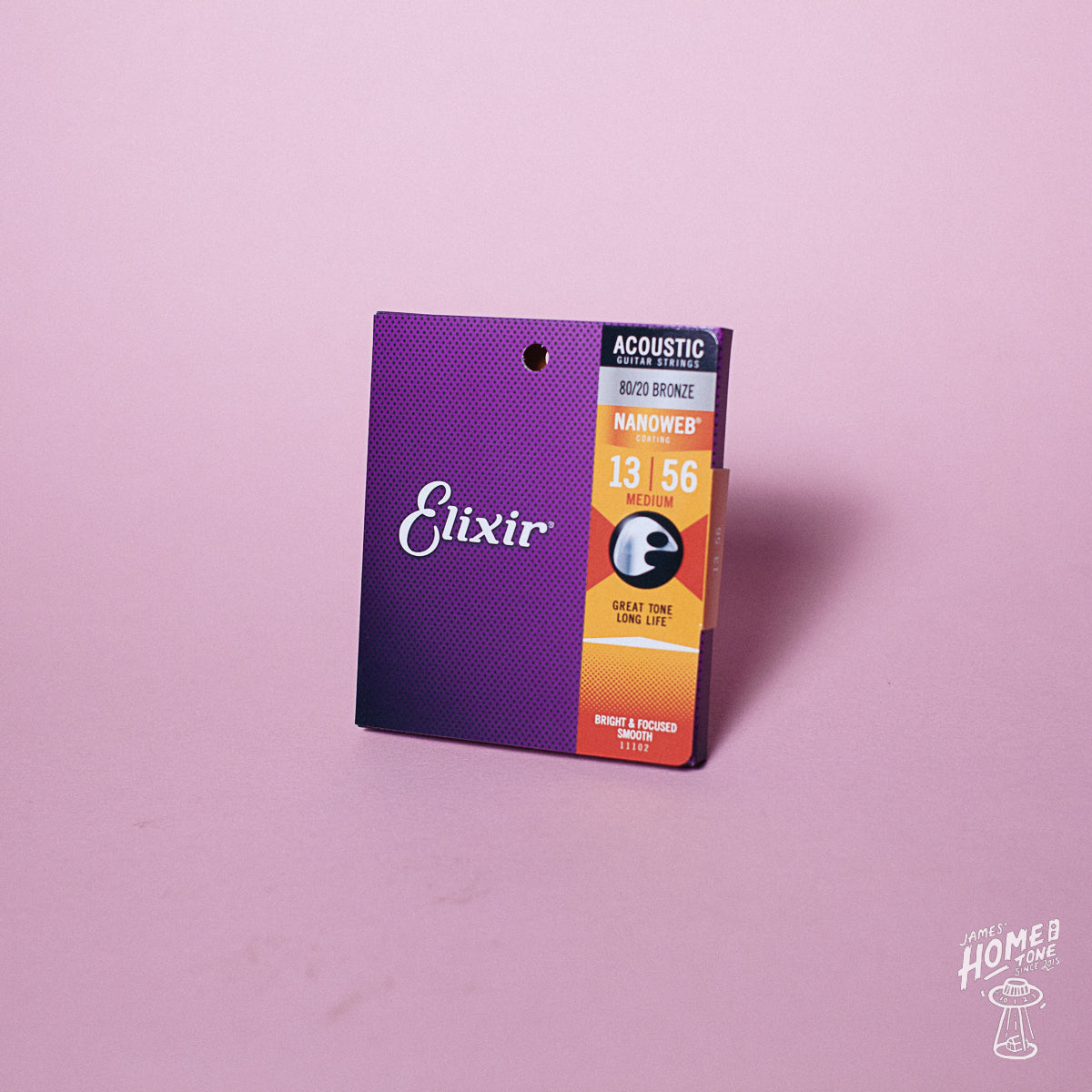 A pack of Elixir Nanoweb coated 80/20 bronze acoustic guitar strings with gauges 13-56 displayed on a purple background.
