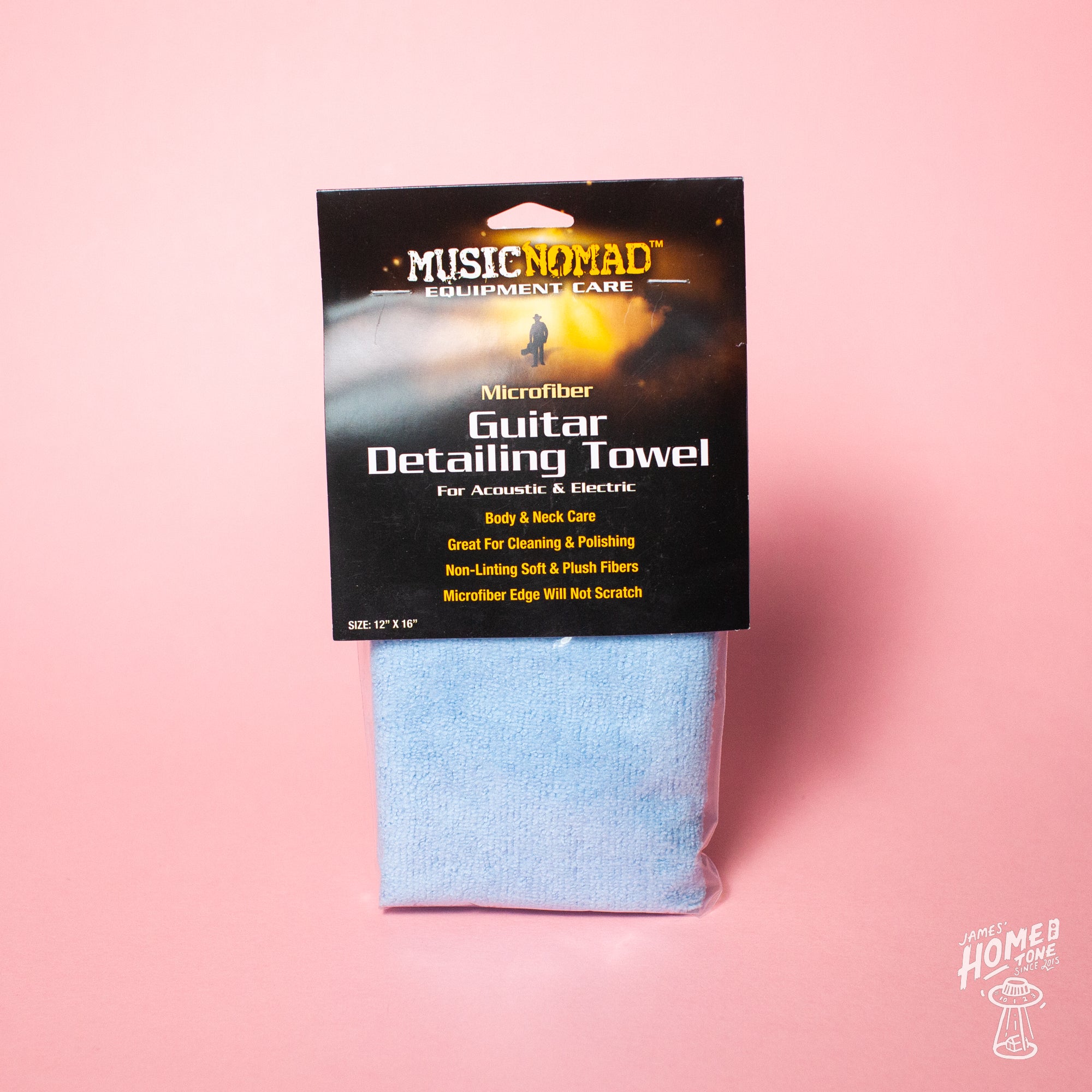 A MusicNomad guitar detailing towel made of microfiber, packaged in a sleeve with branding and product information card on top.