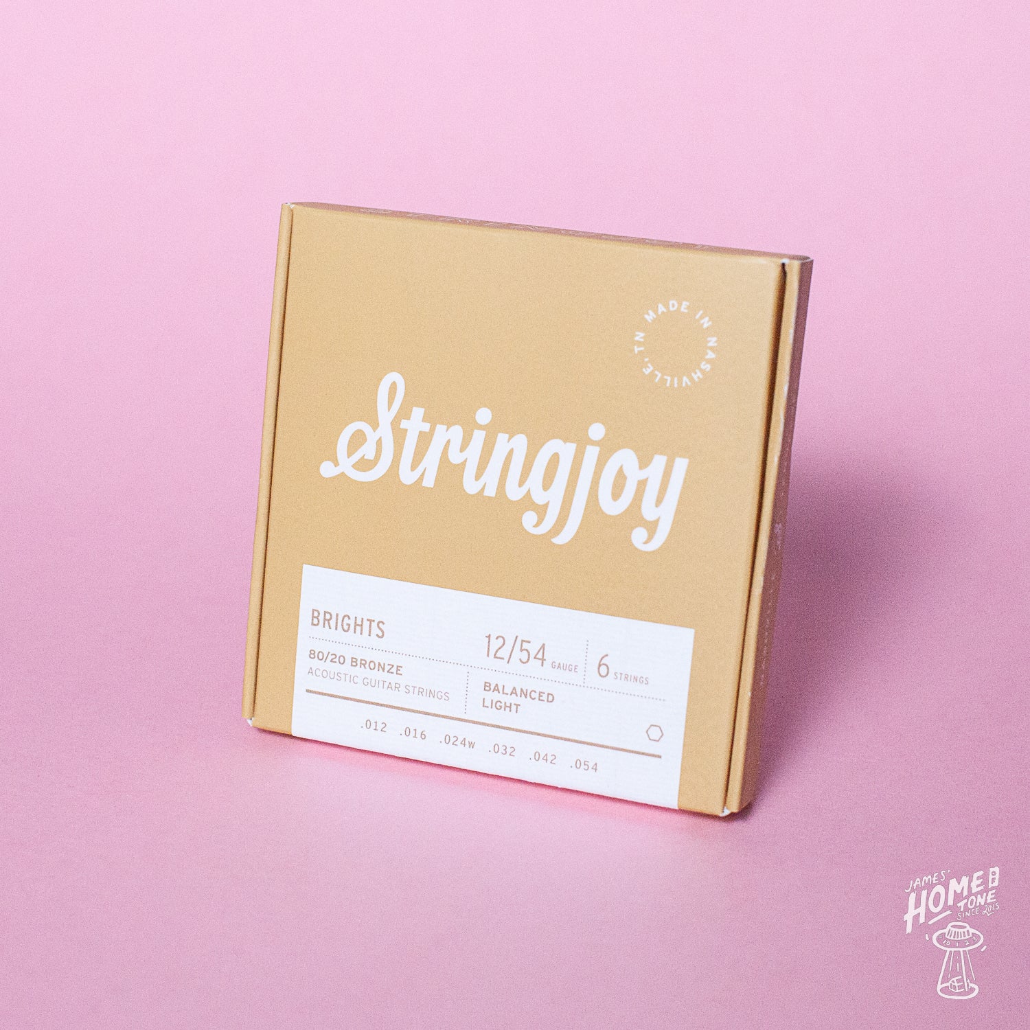 Stringjoy guitar string box on a pink background