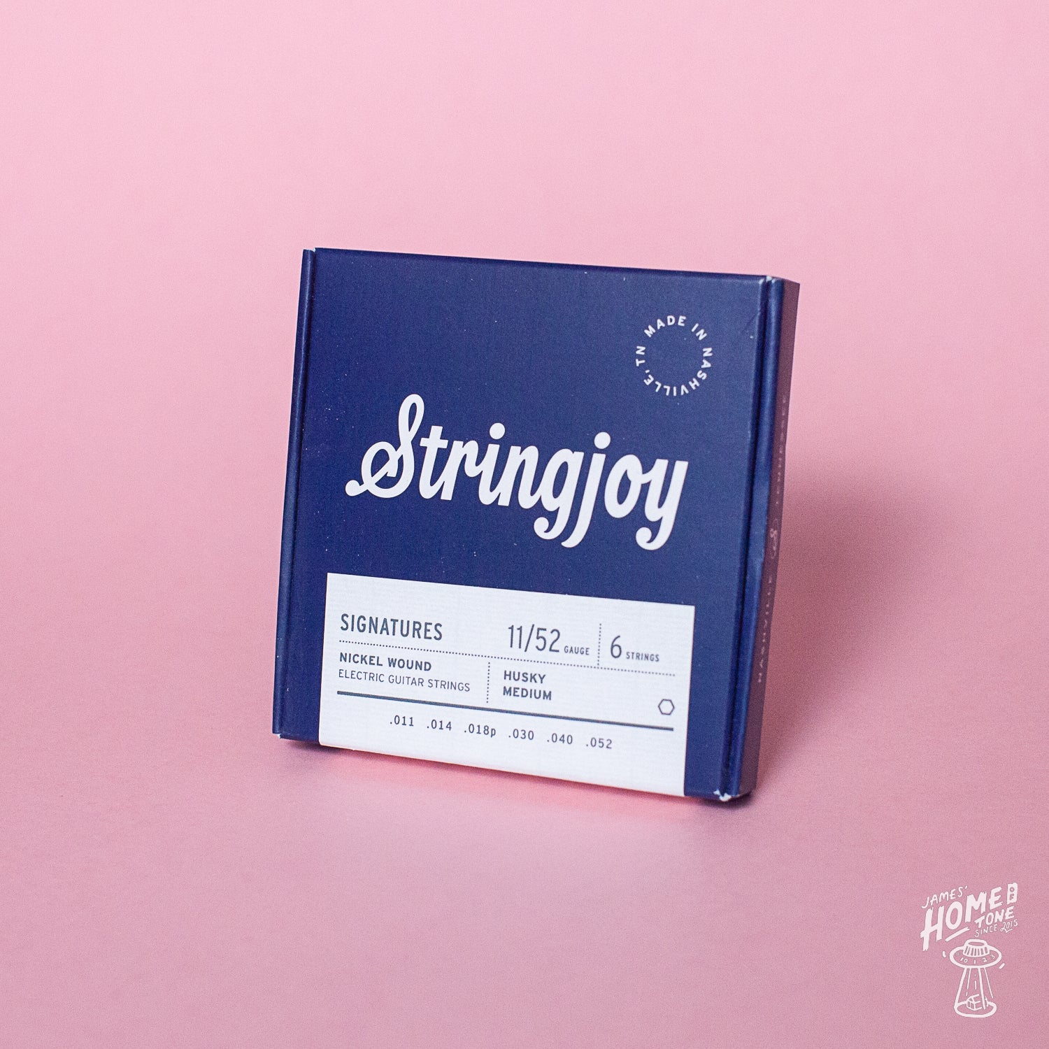 Stringjoy guitar string box on a pink background