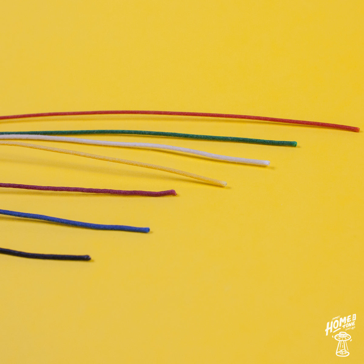 Assorted colors of Gavitt 22AWG cloth covered wires laid out on a yellow background.