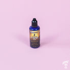 A bottle of MusicNomad Fretboard F-One Oil Cleaner & Conditioner on a pink background.