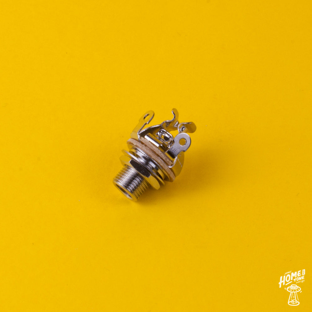 Nickel finish, pure tone multi contact mono jack socket for guitars and basses, displayed on a yellow background.