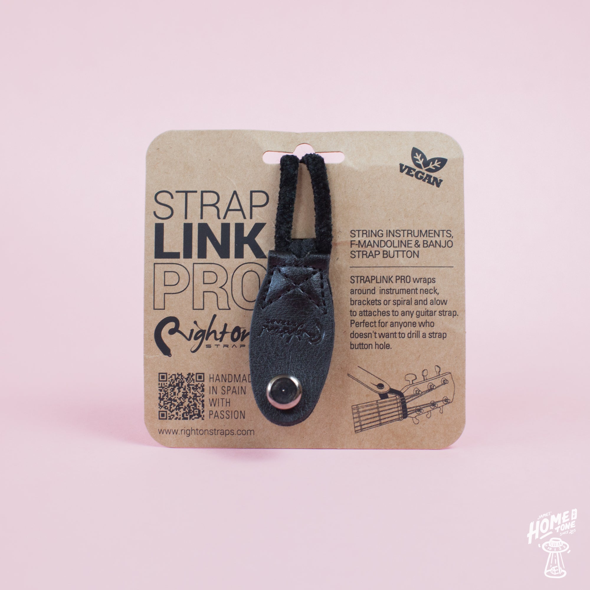Neck Strap Link Pro accessories for guitars displayed on cardboard packaging, one brown and one black, on a pink background.