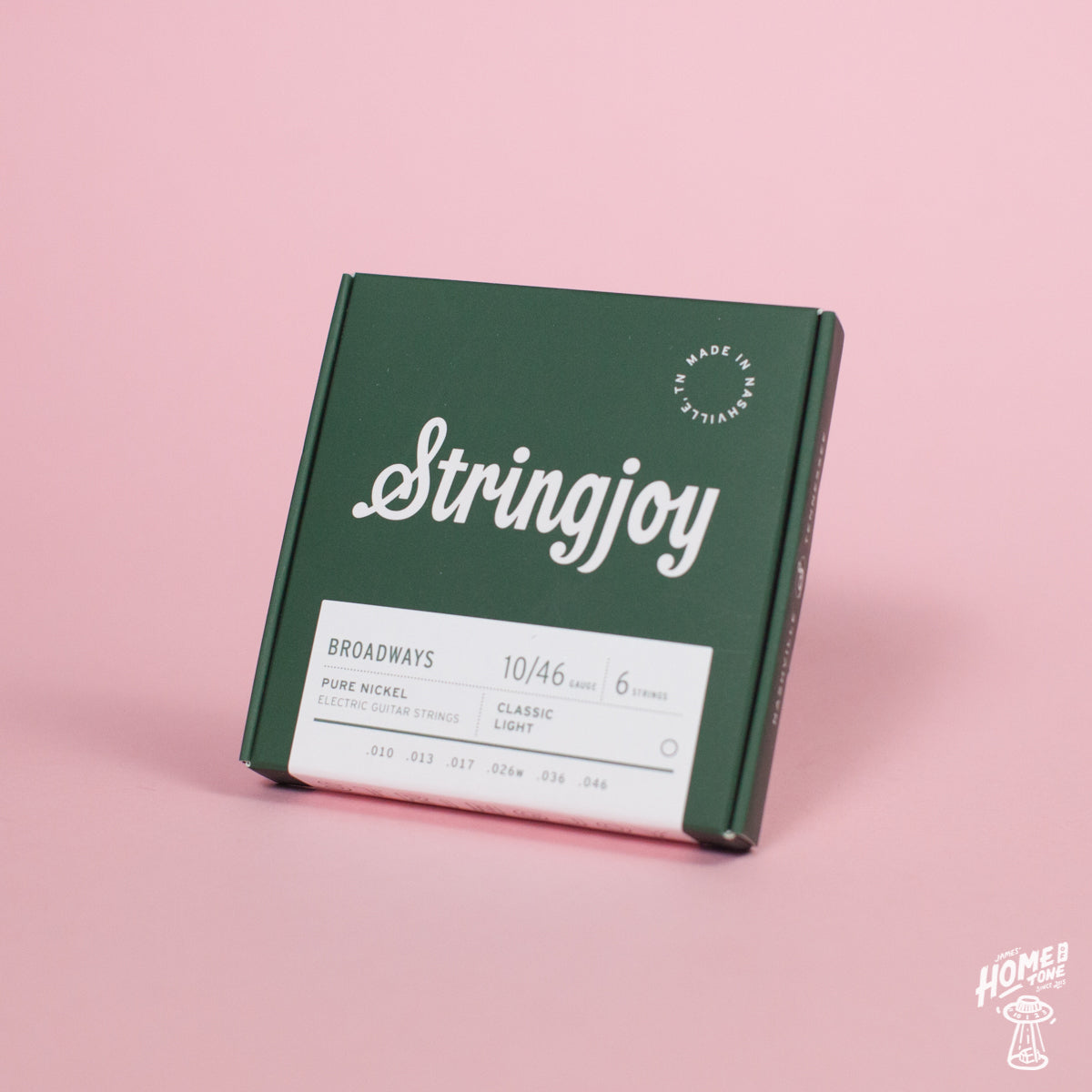 A box of Stringjoy Broadway pure nickel electric guitar strings in classic light gauge, displayed against a pink background.