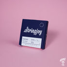 A pack of Stringjoy Signature nickel wound electric bass guitar strings, displaying the gauge size 24-90, placed on a pink background.