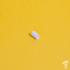 White switchcraft toggle switch tip placed on a yellow background with the Home of Tone logo in the corner